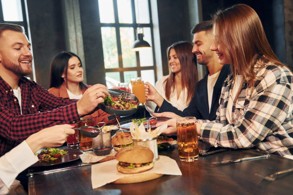 What Makes a Bar or Restaurant Unique? 5 at daytime group of young friends sitting togethe 2021 12 27 17 03 49 utc scaled
