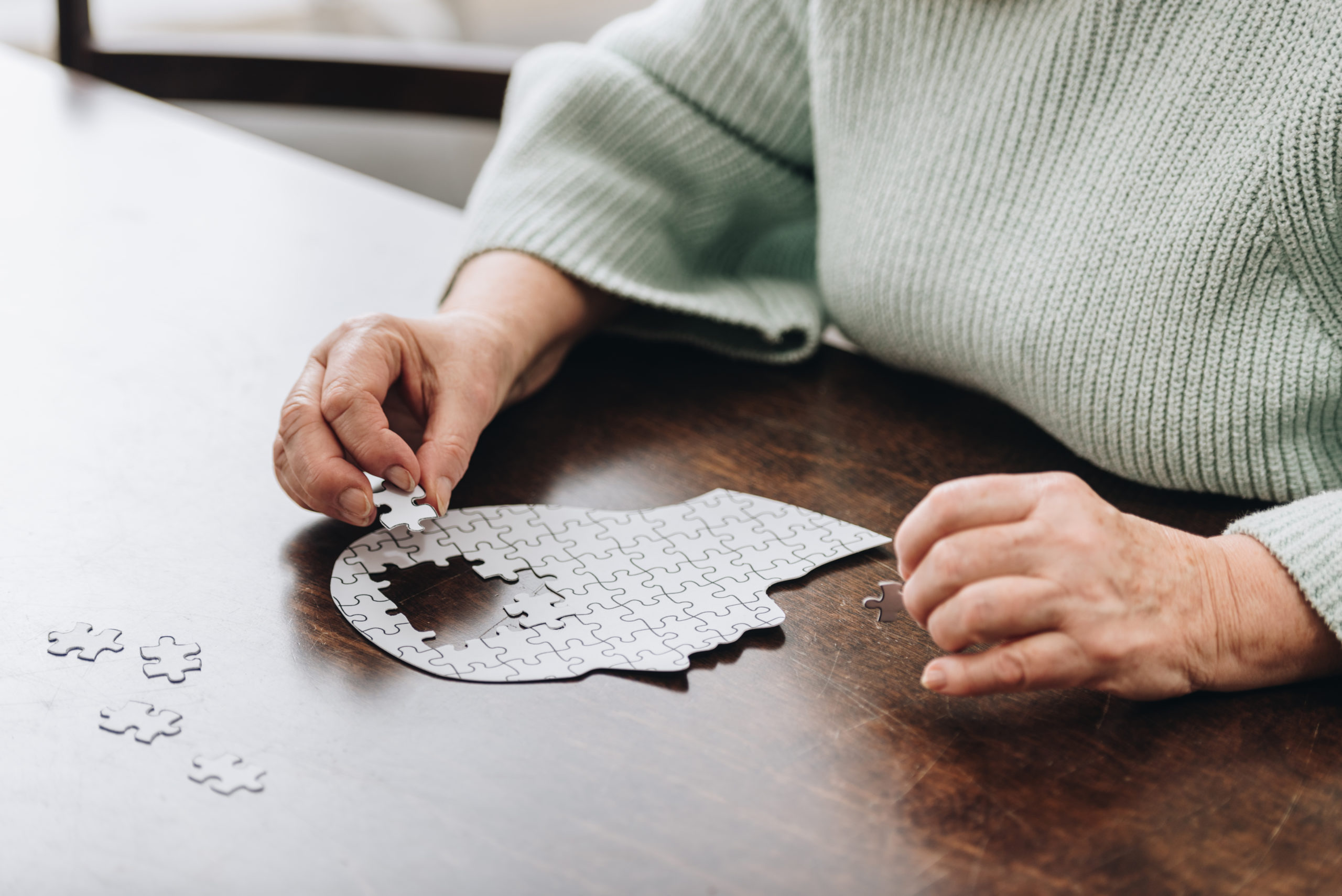 cropped view of senior woman playing with puzzles 2022 12 16 18 57 46 utc scaled